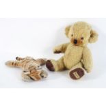 A Steiff tiger cub, asleep, no button, 25cm high; and a Merrythought golden plush teddy bear,