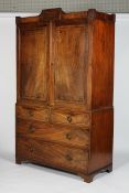 An early 19th century mahogany linen press, inlaid with ebonised geometric stringing,