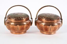 A pair of Chinese copper censers, of slightly lobed form, the cover pierced with scrolling dragons,