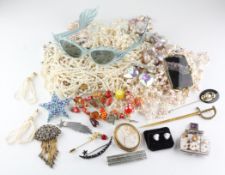 A large collection of costume jewellery to include nine brooches, A large abstract pendant,