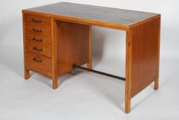 A 20th century vintage golden oak pedestal desk having a single bank of five drawers