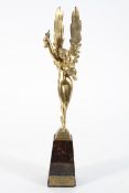 A French brass figure of a winged maiden, holding a bowl and ewer, on a marble plinth,