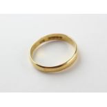 A yellow metal D shape 4mm wedding ring. Hallmarked 22ct gold, Birmingham, 1927 Size S