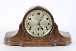 An oak mantel clock, the silvered dial inscribed Camerer, Cuss and Co, London,