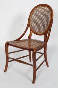A Victorian walnut mahogany nursing chair, with caned back and seat,