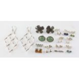 A collection of twelve pairs of silver earrings of variable designs. Some are marked for silver.