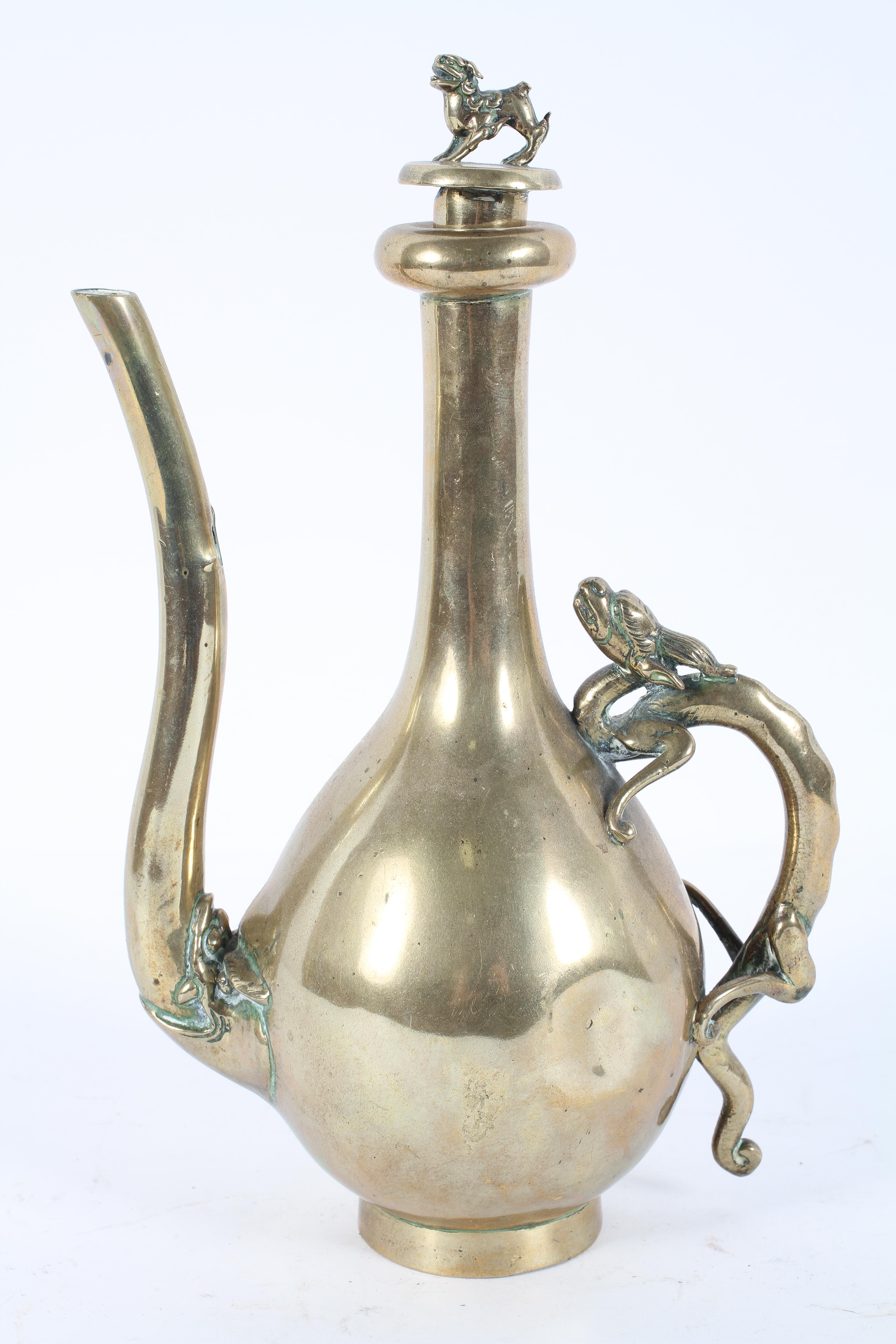 A Chinese brass ewer, of gourd form, with chilong handle and dragon finial,