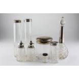 A collection of silver capped glass dressing table bottles and two salts,