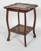 An Arts and Crafts carved oak occasional table, carved with quatrefoils and foliate panels,