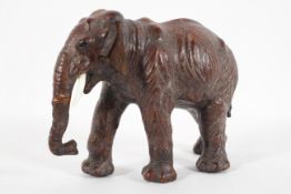 A leather figure of an Indian elephant walking,