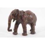 A leather figure of an Indian elephant walking,