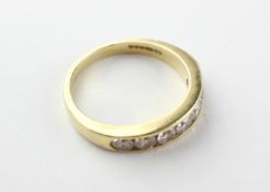 A yellow metal half hoop ring.