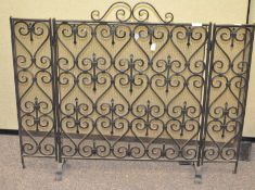 A three fold iron and mesh fire screen,