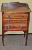 A mahogany filing cabinet with three drawers,