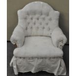 An upholstered armchair with button back,