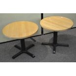 A pair of round topped cast metal low occasional tables,