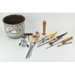 A collection of corkscrews and carving knives,