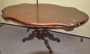A reproduction highly polished dining table, raised upon four point central leg,