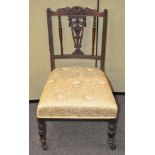 An Edwardian mahogany nursing chair with embroidered fabric seat,