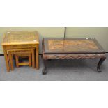 A nest of three oriental tables with a long similar coffee table,