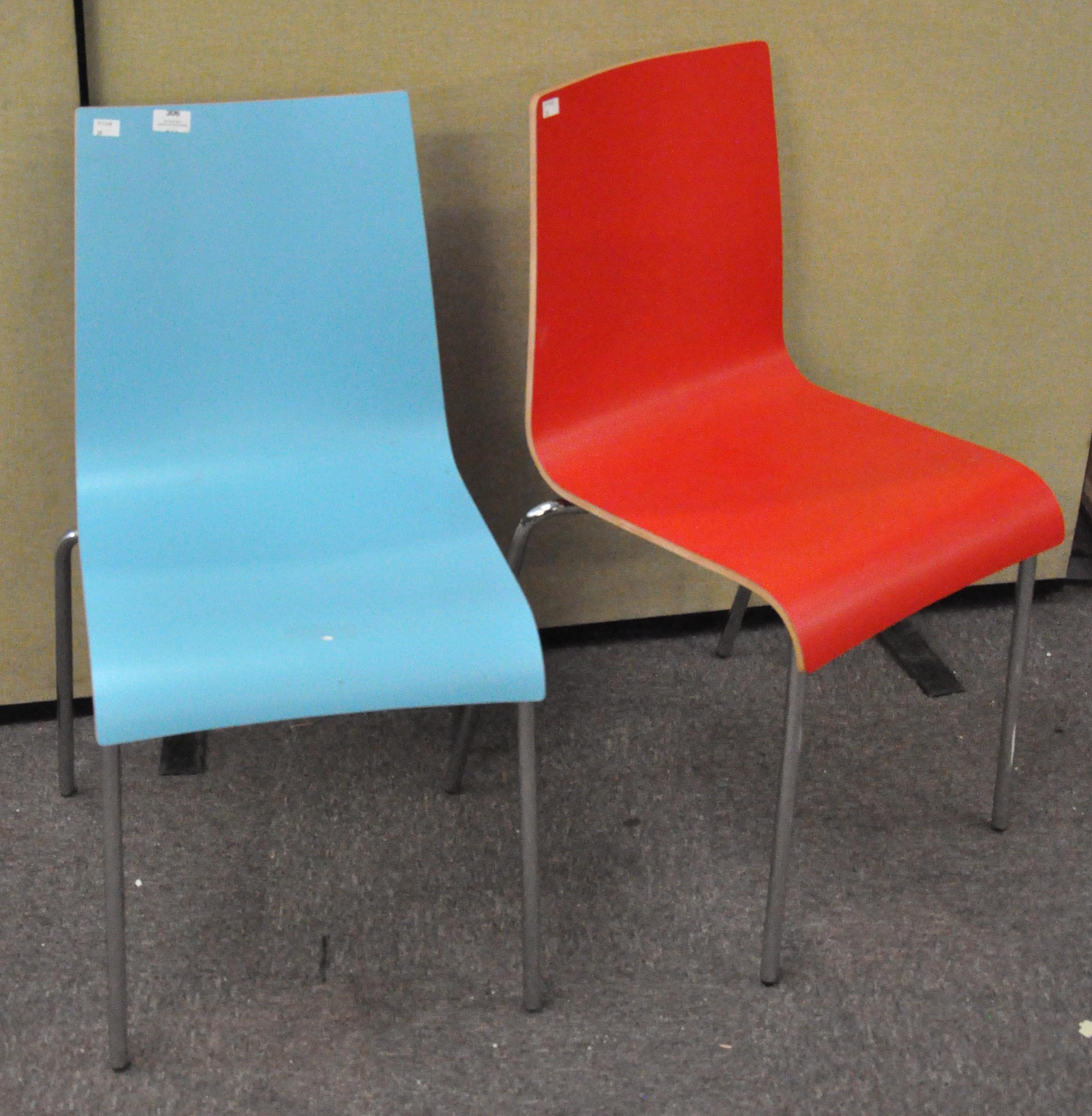 A pair of modern colourful chairs with metal legs,