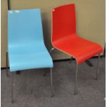 A pair of modern colourful chairs with metal legs,