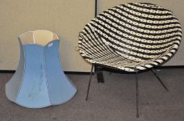 A satelite chair and a blue lampshade