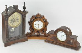 A group of three mantel clocks, the largest by the Hamburg American Clock company,