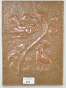 A rectangular Arts and Crafts copper plaque of two birds, circa 1920,