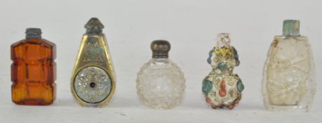 A group of assorted scent bottles, comprising three glass, one ceramic and one metal,