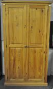 A 20th century pine two door wardrobe,