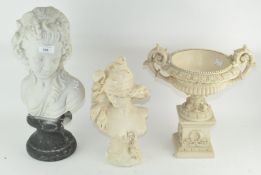 Two white resin busts of females, each raised on a pedestal base,