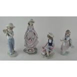 A collection of Lladro figurines, including a boy holding a bag of flowers 27745,