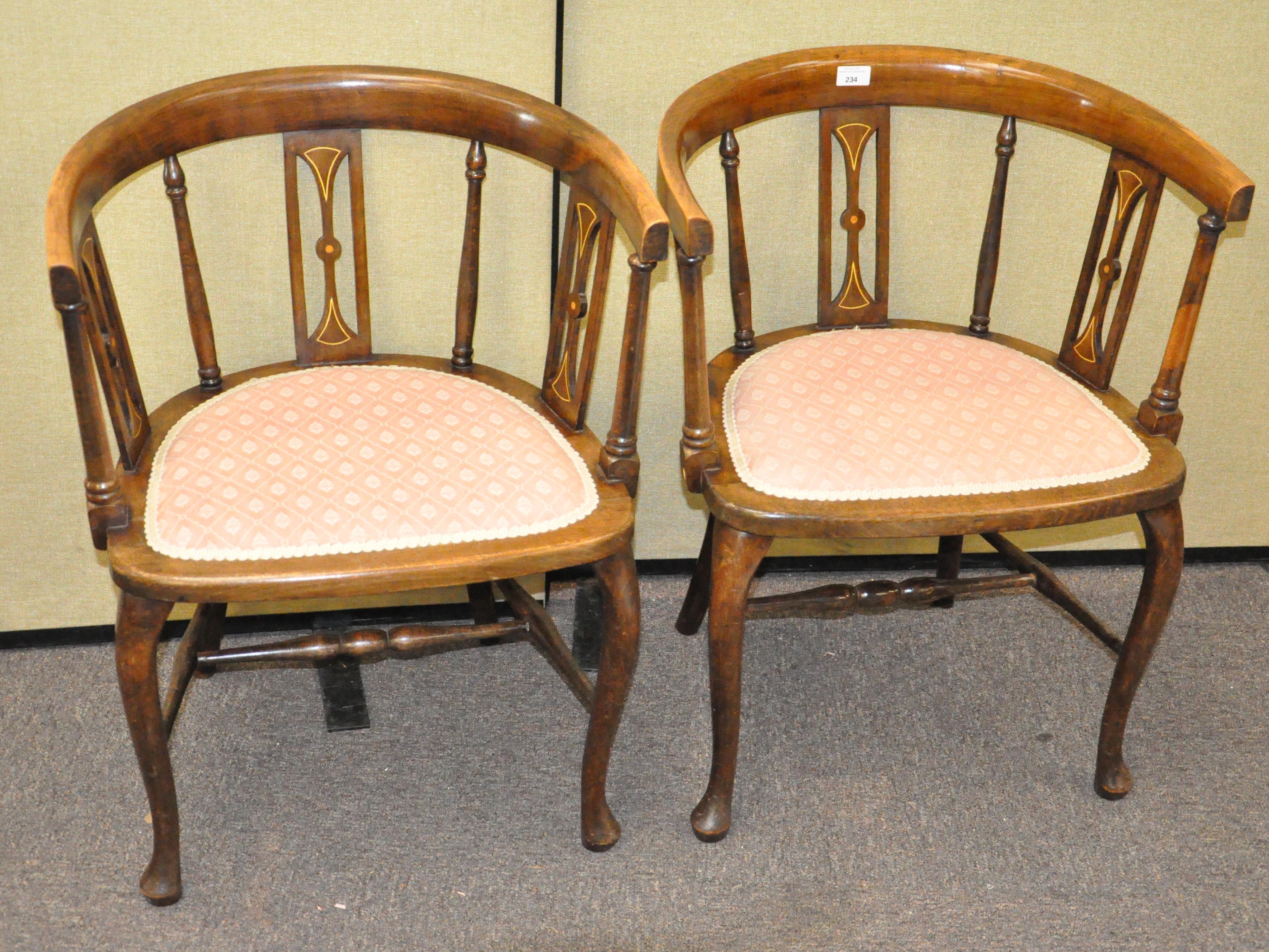 A pair of mahogany tub chairs with inlaid decoration to the back, upholstered seat,