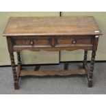 A barley twist oak side table/desk with two drawers to the front,