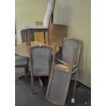 A modern dining table together with a set of six matching chairs,