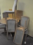 A modern dining table together with a set of six matching chairs,