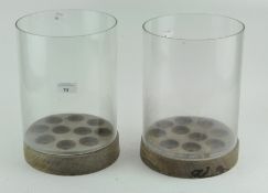 A pair of unusual wooden and glass candle holders,