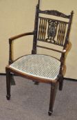 An Edwardian mahogany elbow chair,