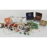 A collection of costume jewellery and a cigarette box