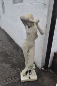 A large resin garden statue of a semi-nude lady, in the style of white marble,