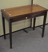 A 20th century oak tilt top dining table, raised upon tapering legs,