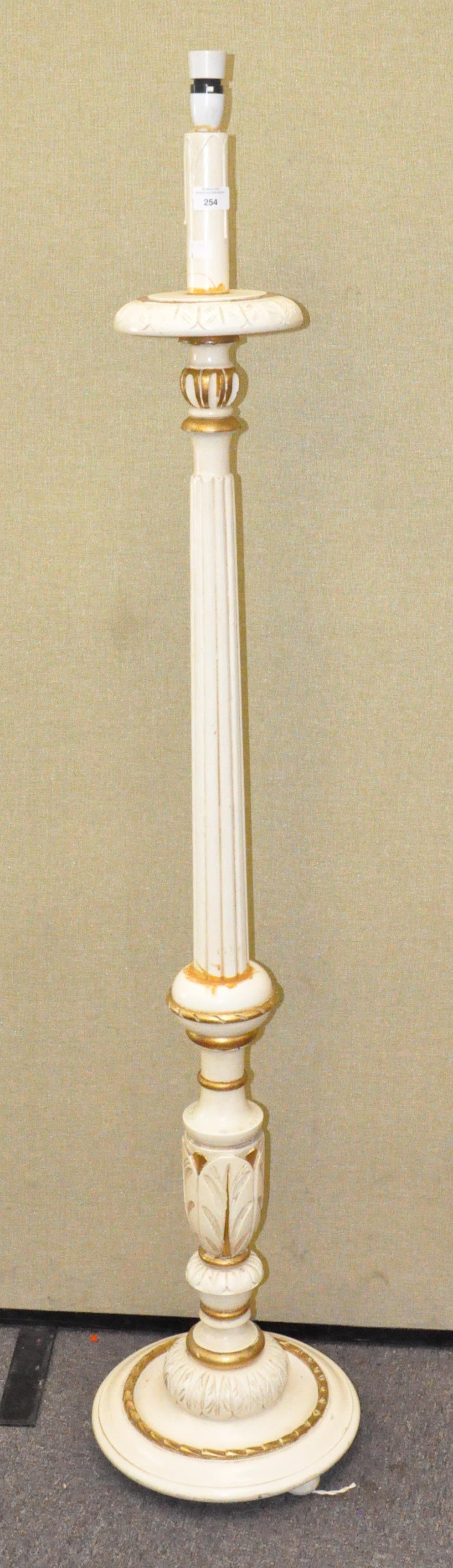 A white painted standard lamp with gilt detailing,