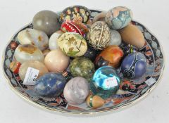 A collection of stone, glass and specimen eggs and a Japanese dish,