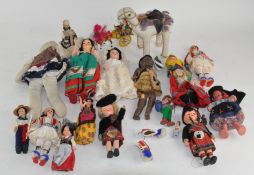 A collection of dolls and figures of varying sizes and designs,