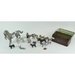 An assortment of metal animals, including a gun dog holding a bird and many more,