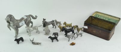 An assortment of metal animals, including a gun dog holding a bird and many more,