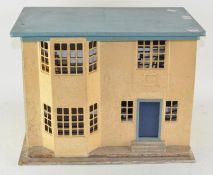 A vintage tin plate front dolls house, containing a small selection of dolls house furniture,