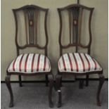 Two dining chairs with inlaid decoration and upholstered seats,