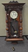 A large stained Oak Vienna wall clock with carved decoration throughout,